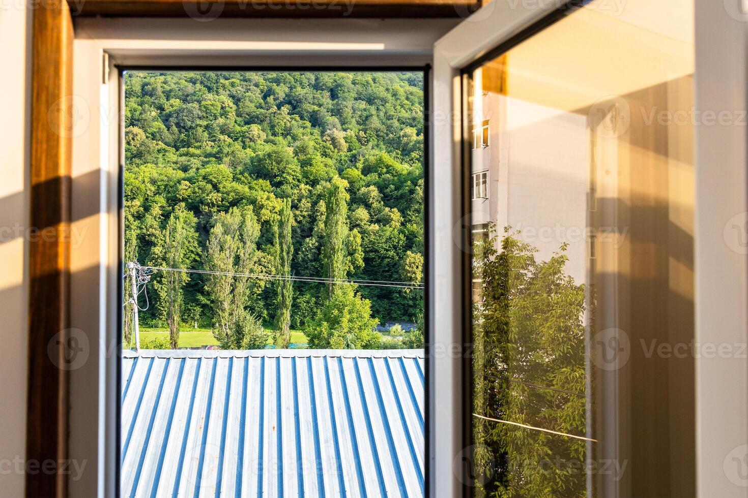 roof and forest through open window in Dilijan photo
