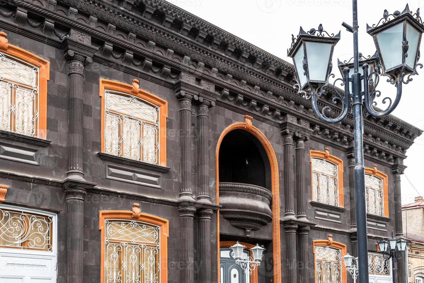 lantern and old house from black tuff in Gyumri photo