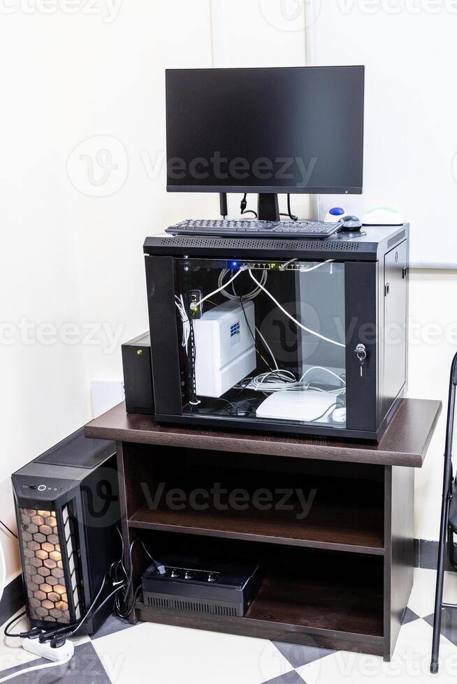 stand with server, router, computer monitor photo