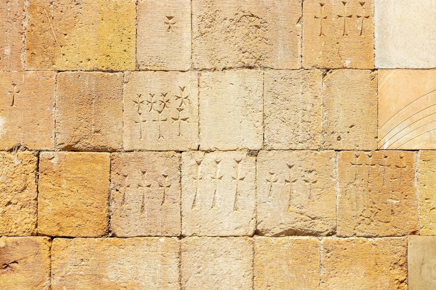 outer wall of church with carved memorial crosses photo