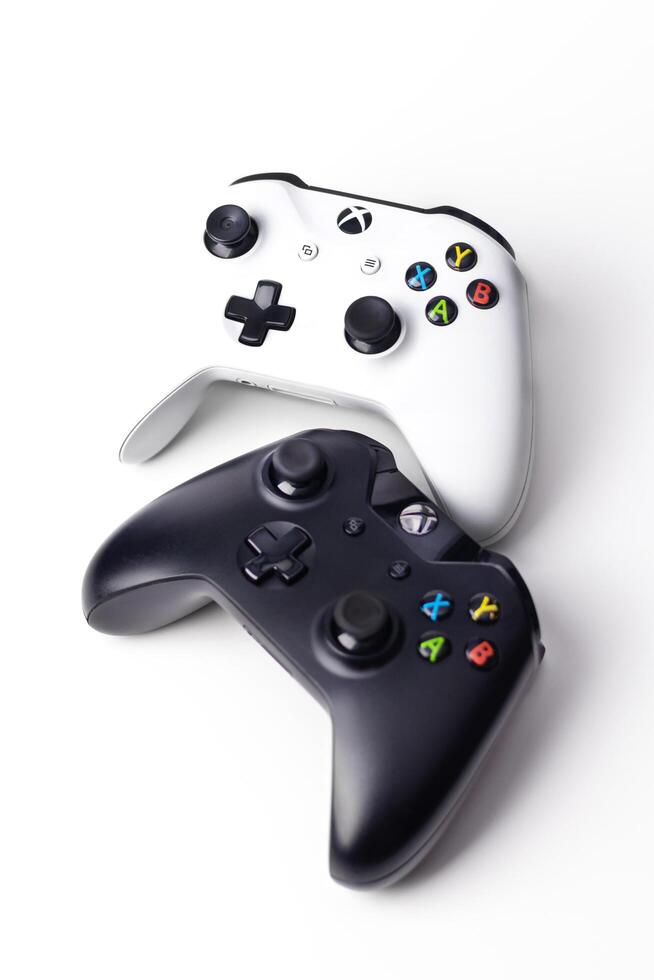 Xbox One S Black and White Controllers, joysticks, on white background vertical photo