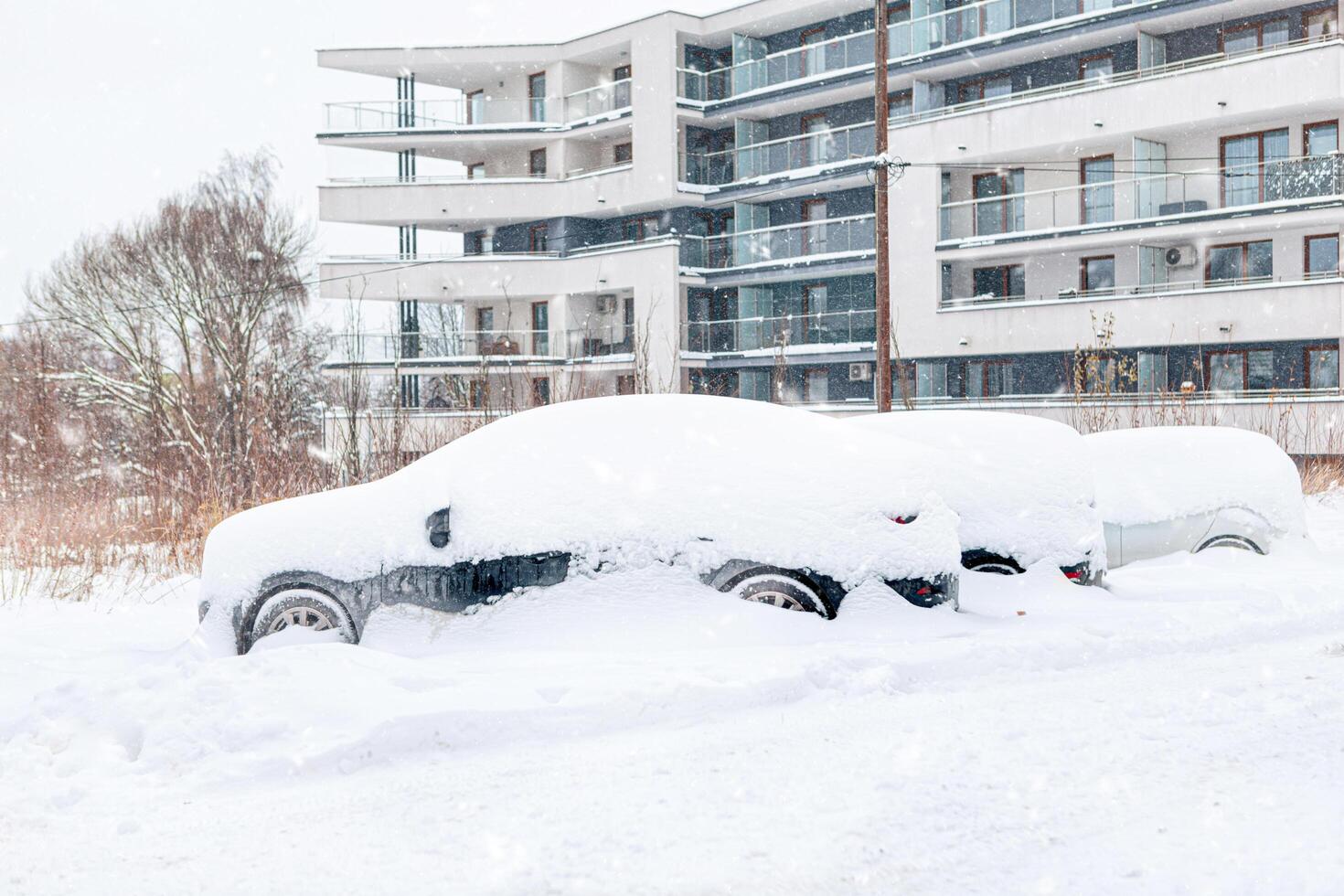 Poland, Krakow, 12.03.2023, snowfall, snowy street with cars after a blizzard photo