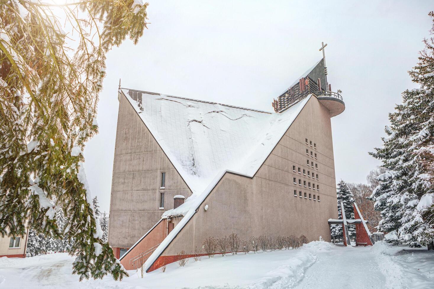 snowy church after a blizzard, avalanche danger, snow falling from the roof photo