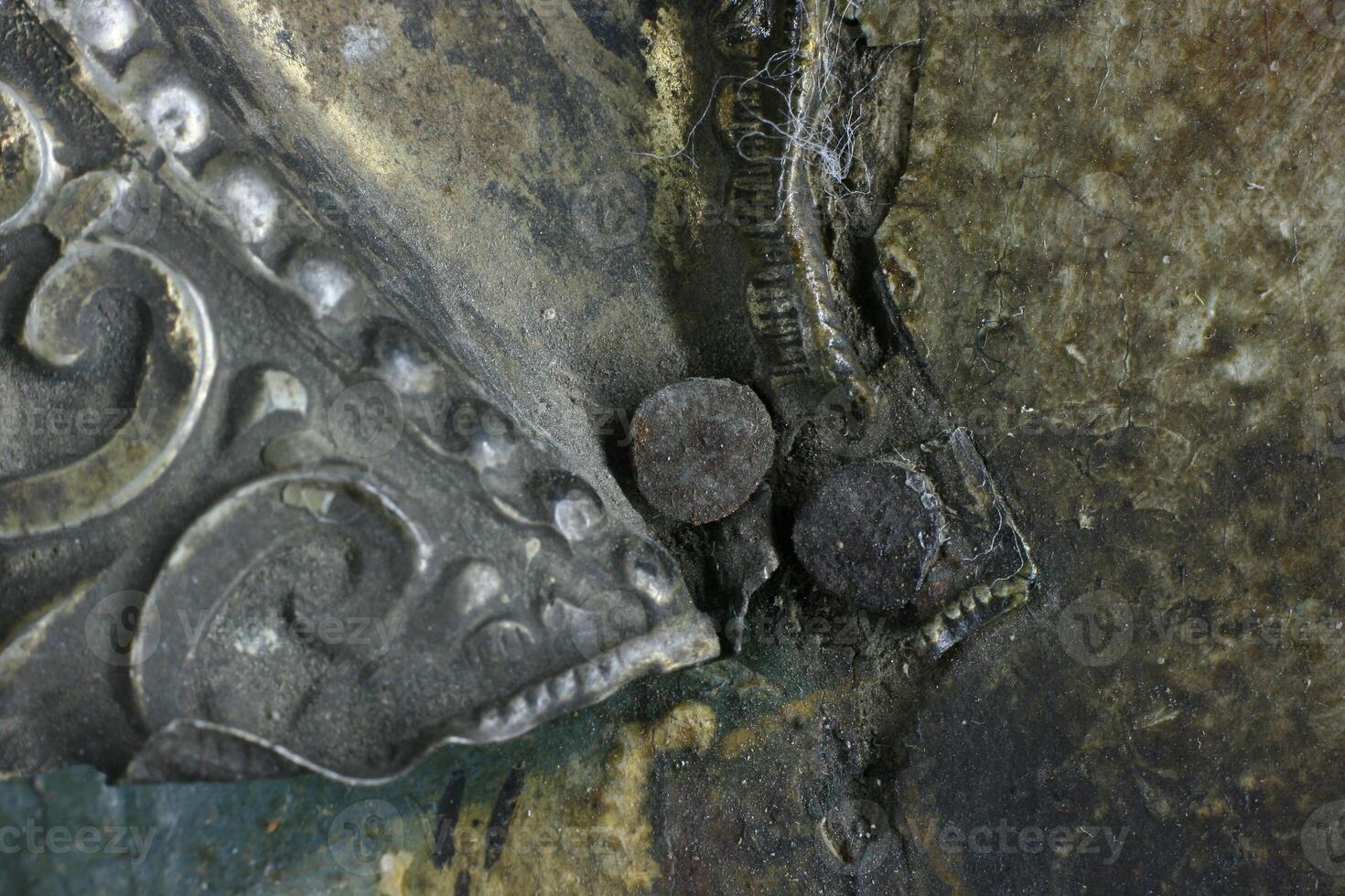 old-fashioned nail on the icon. restoration of metal photo