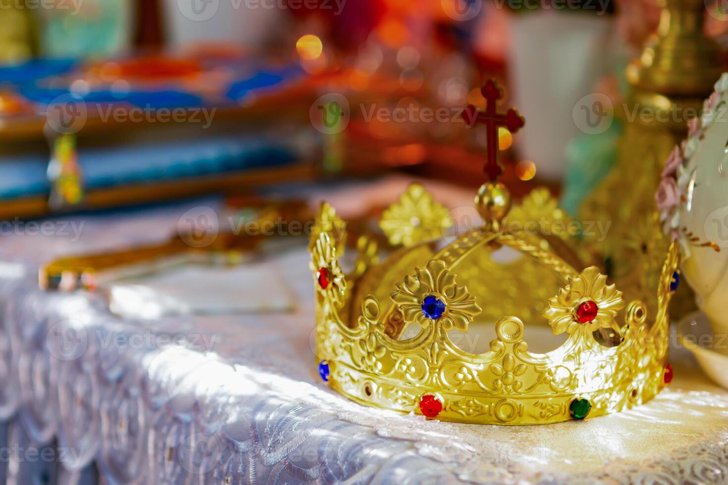 Golden Crown With Colorful Jewels Displayed on a Decorated Altar in a Serene Setting. photo