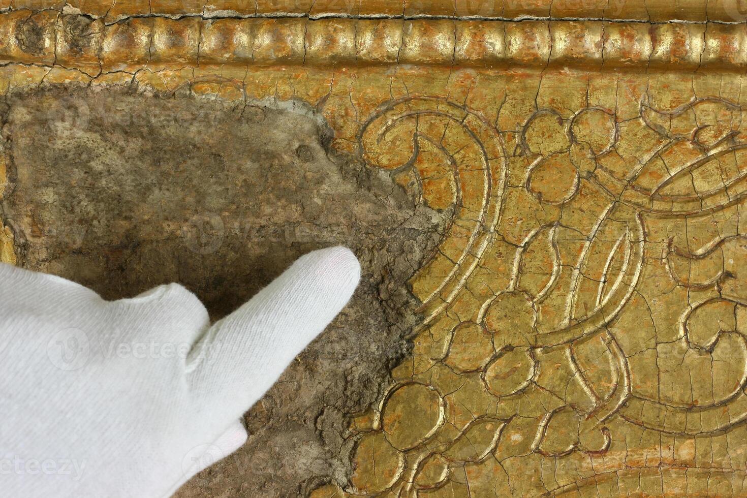 Restoration gold restoration, old icon. close up. conservation of paintings. conservation of sculptures photo