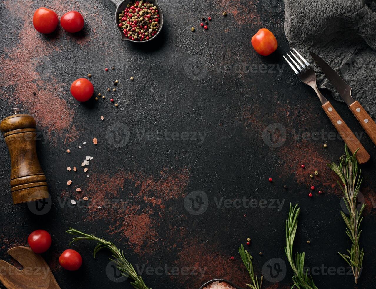 Culinary composition with kitchen utensils and spices, Himalayan salt, colorful peppercorns, fresh rosemary on the table. Top view photo