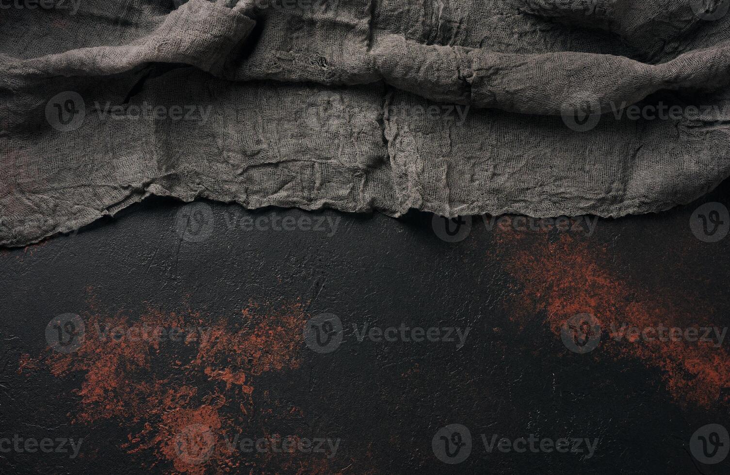 Black gauze kitchen towel on black brown surface, top view. Copy space photo