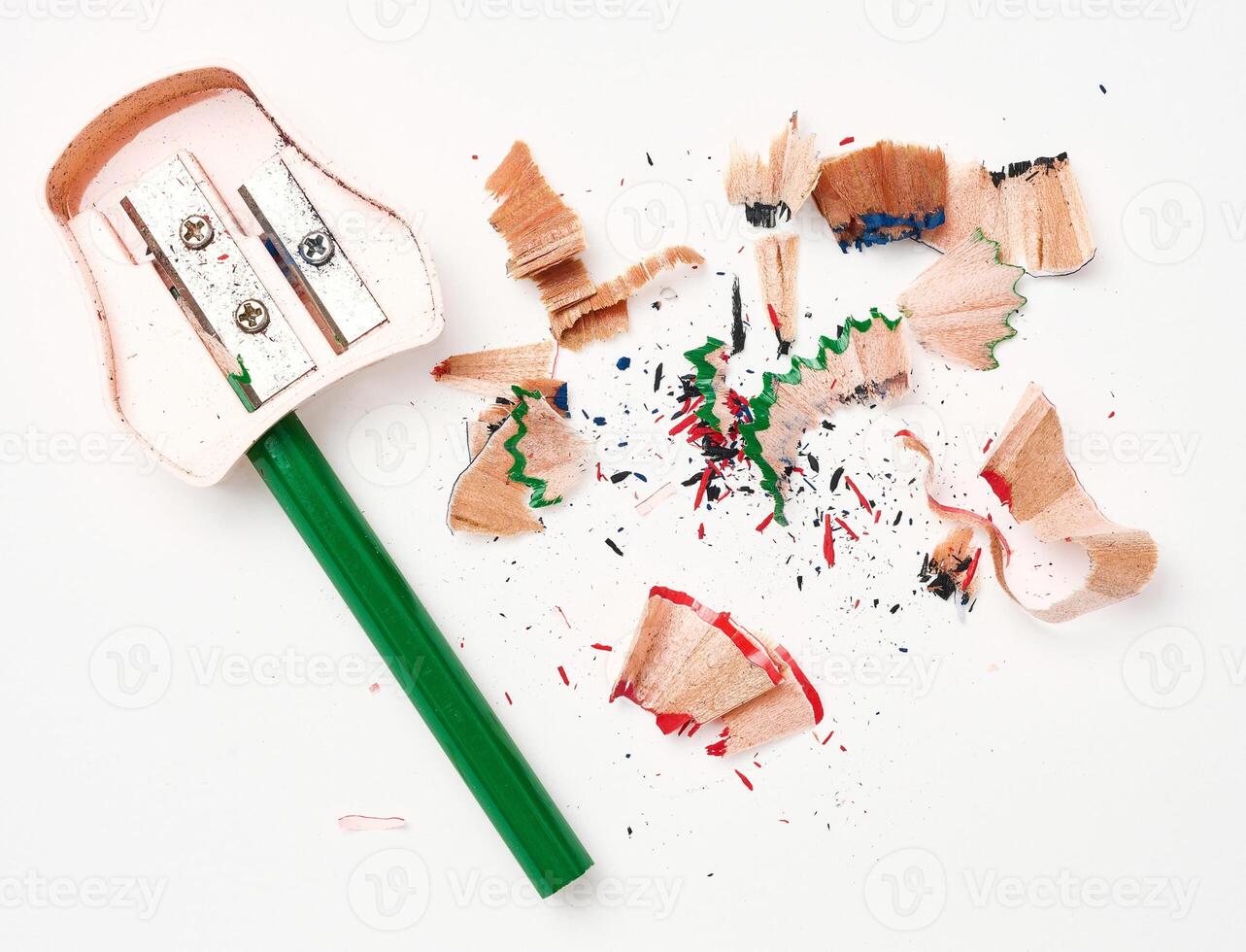 Green wooden pencil and sharpener on white background, top view photo