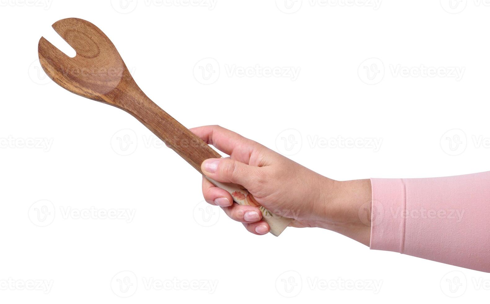 Woman's hand holds a wooden spoon on a white background, close up photo