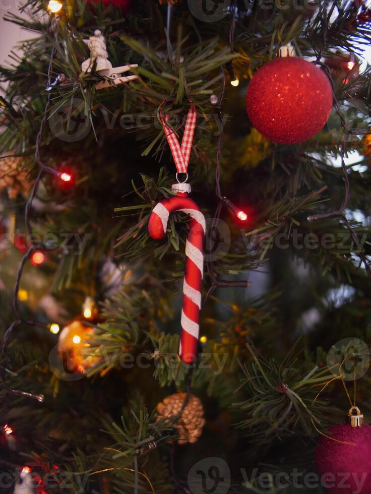 Decorated Christmas tree. Christmas tree decor in the shape of candy cane. Christmas and New Year celebration concept. Background wallpaper, banner photo