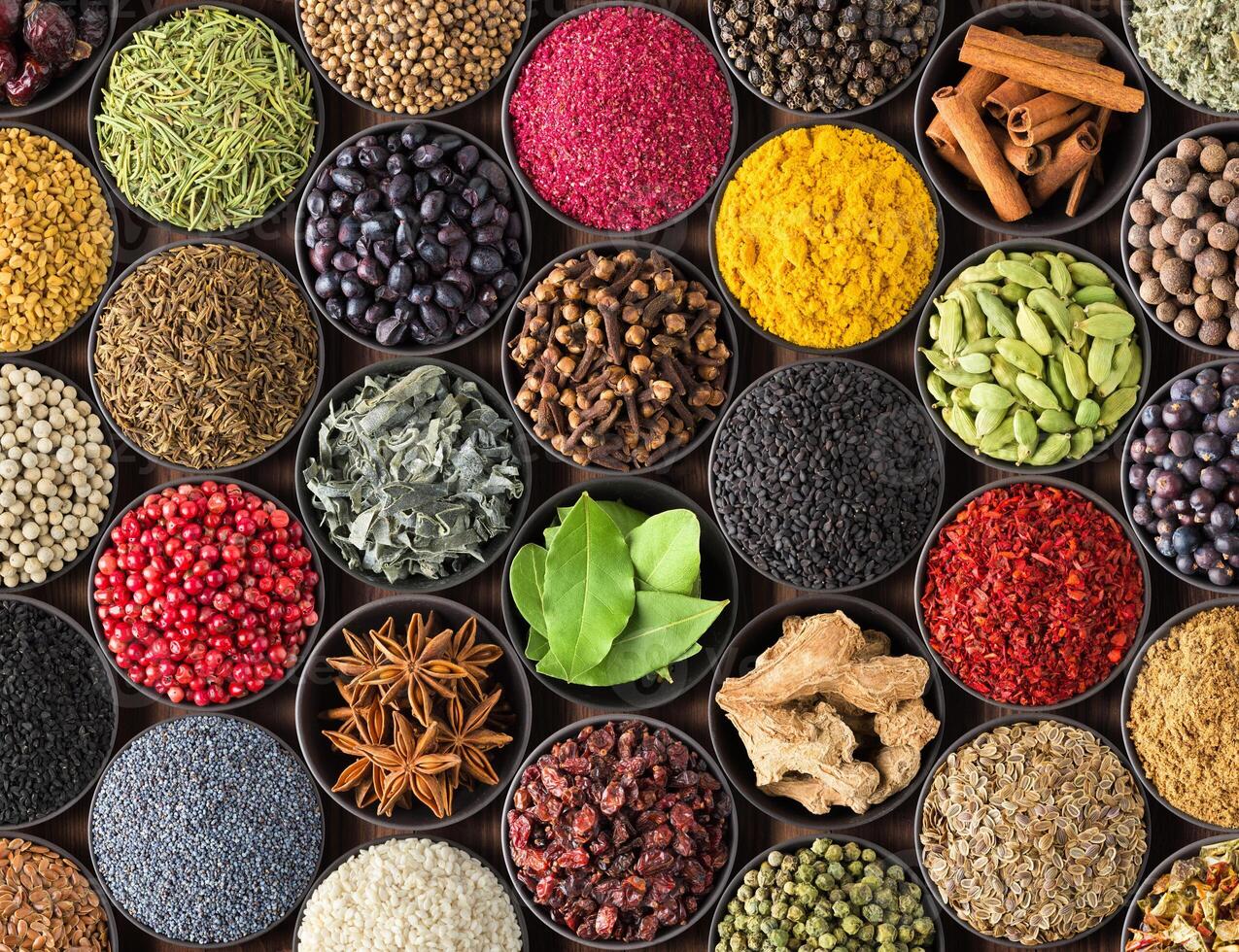 bright Indian spices and herbs in cups, top view. background for packing with condiments. photo