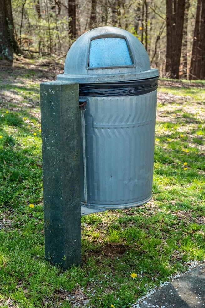 Garbage can in a park photo