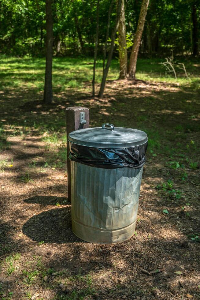 Garbage can with lid outdoors photo