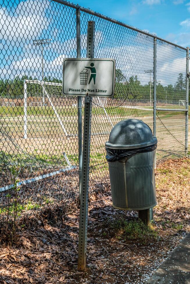 Please Do Not Litter sign with garbage can photo