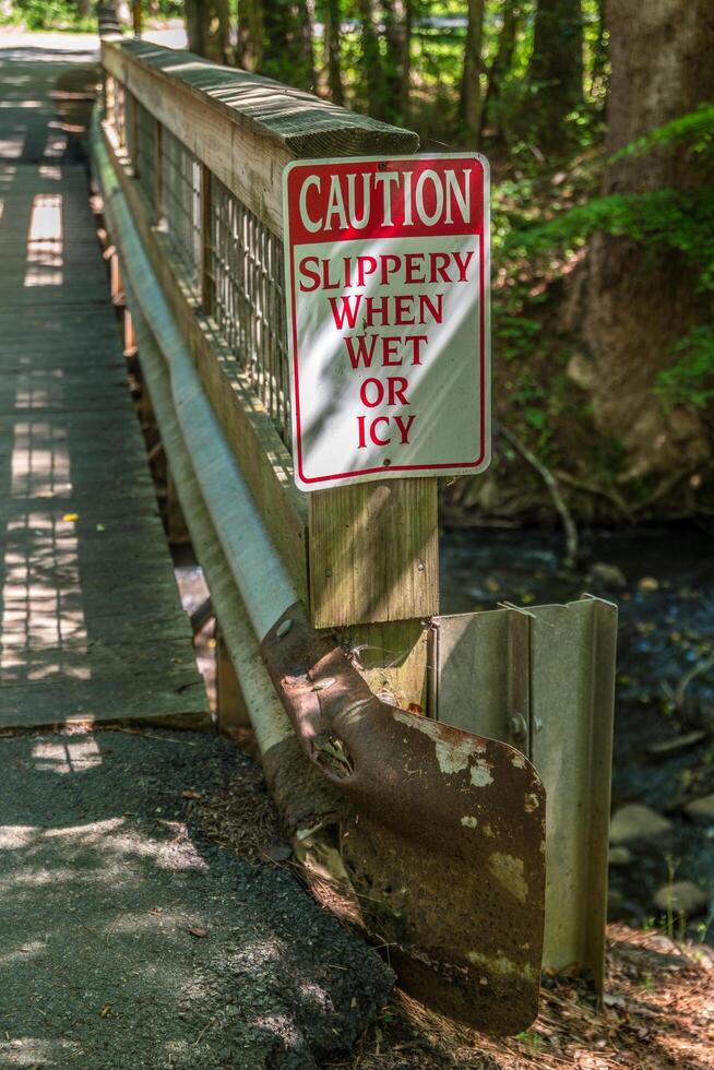 Guard rail on bridge with signage photo