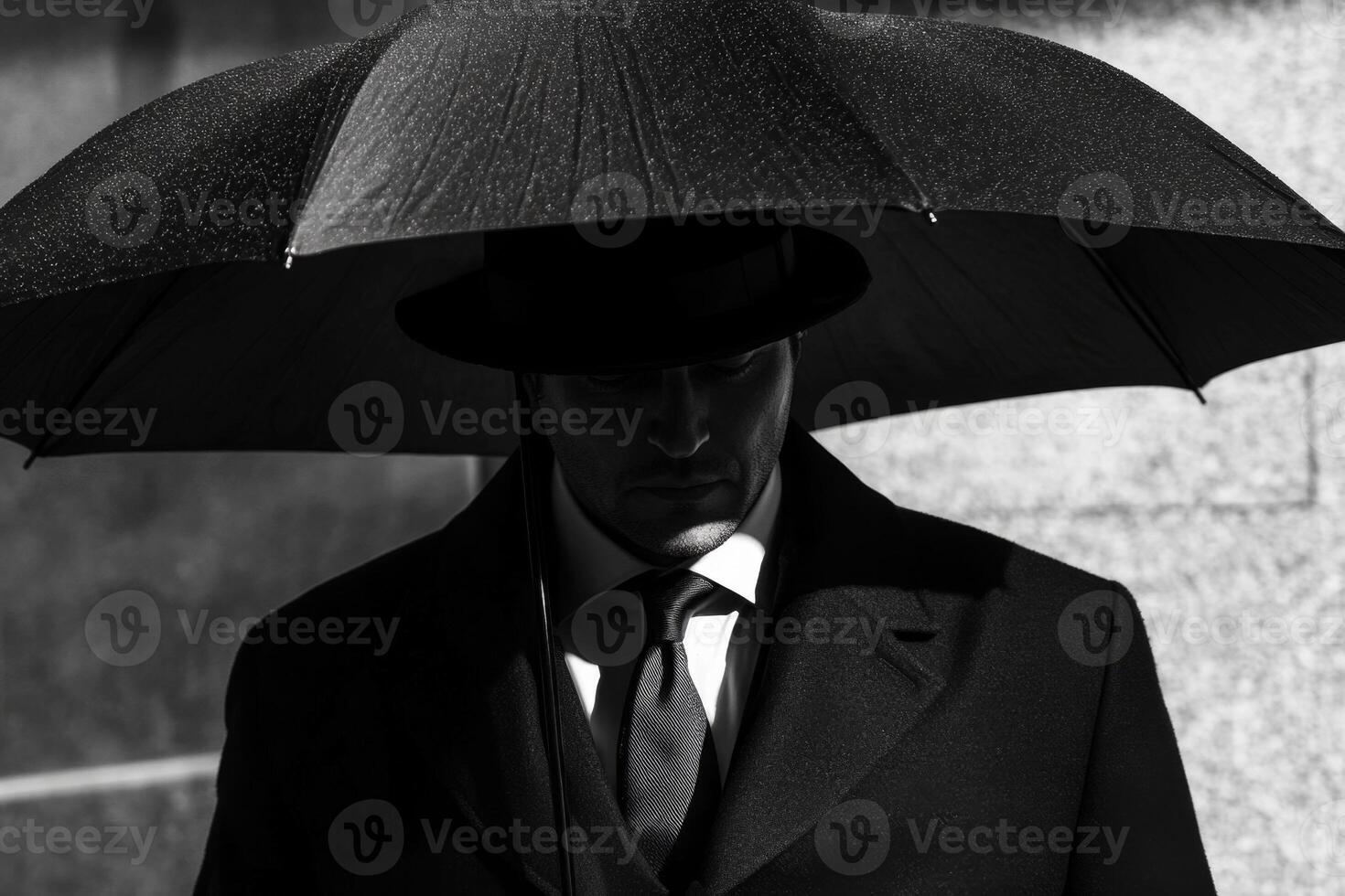 Businessman holding umbrella standing in the rain photo