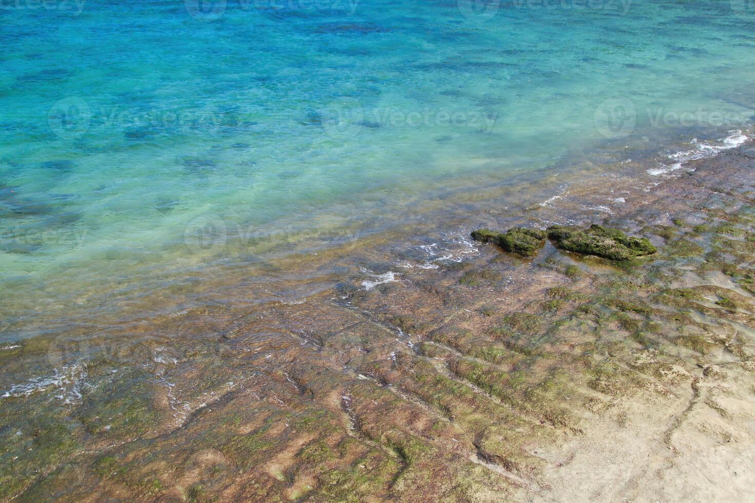 Beautiful beach view with very clear deep blue sea with small waves and beautiful beach sand at Balaikambang beach Malang Indonesia photo