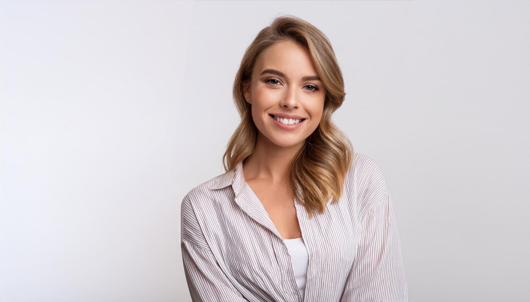a young European woman in a casual shirt smiling warmly at the camera. This cheerful and confident image is perfect for corporate, business, lifestyle, and personal branding projects photo