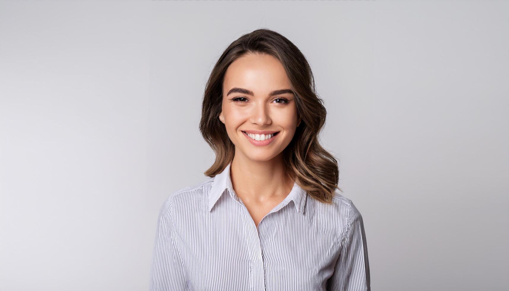 a young European woman in a casual shirt smiling warmly at the camera. This cheerful and confident image is perfect for corporate, business, lifestyle, and personal branding projects photo