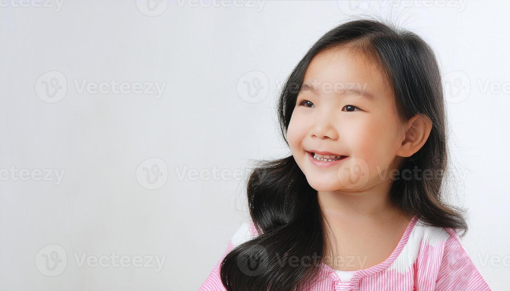 a beautiful baby girl lying on a white bed, smiling with delight. The clean, minimalistic background emphasizes the child is joyful expression and innocence, early childhood, and nurturing care photo