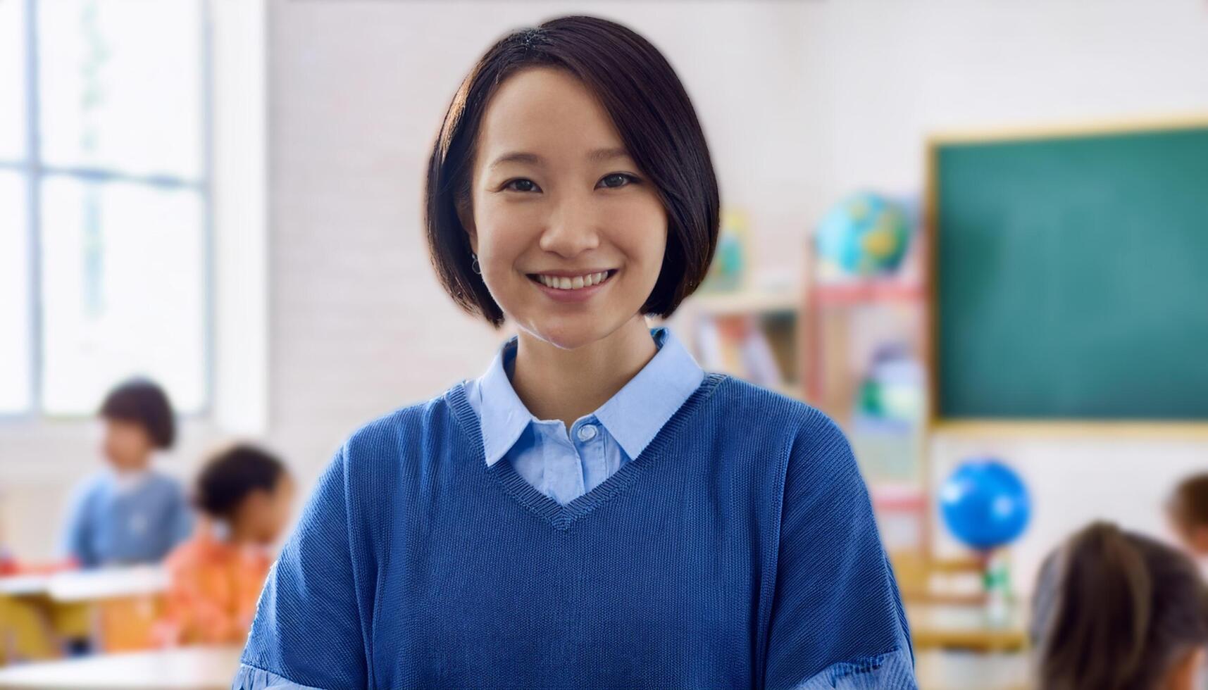 Japanese preschool teacher smiling warmly in a classroom filled with children. The teacher, The vibrant learning environment in the background makes this image perfect for educational themes, school photo