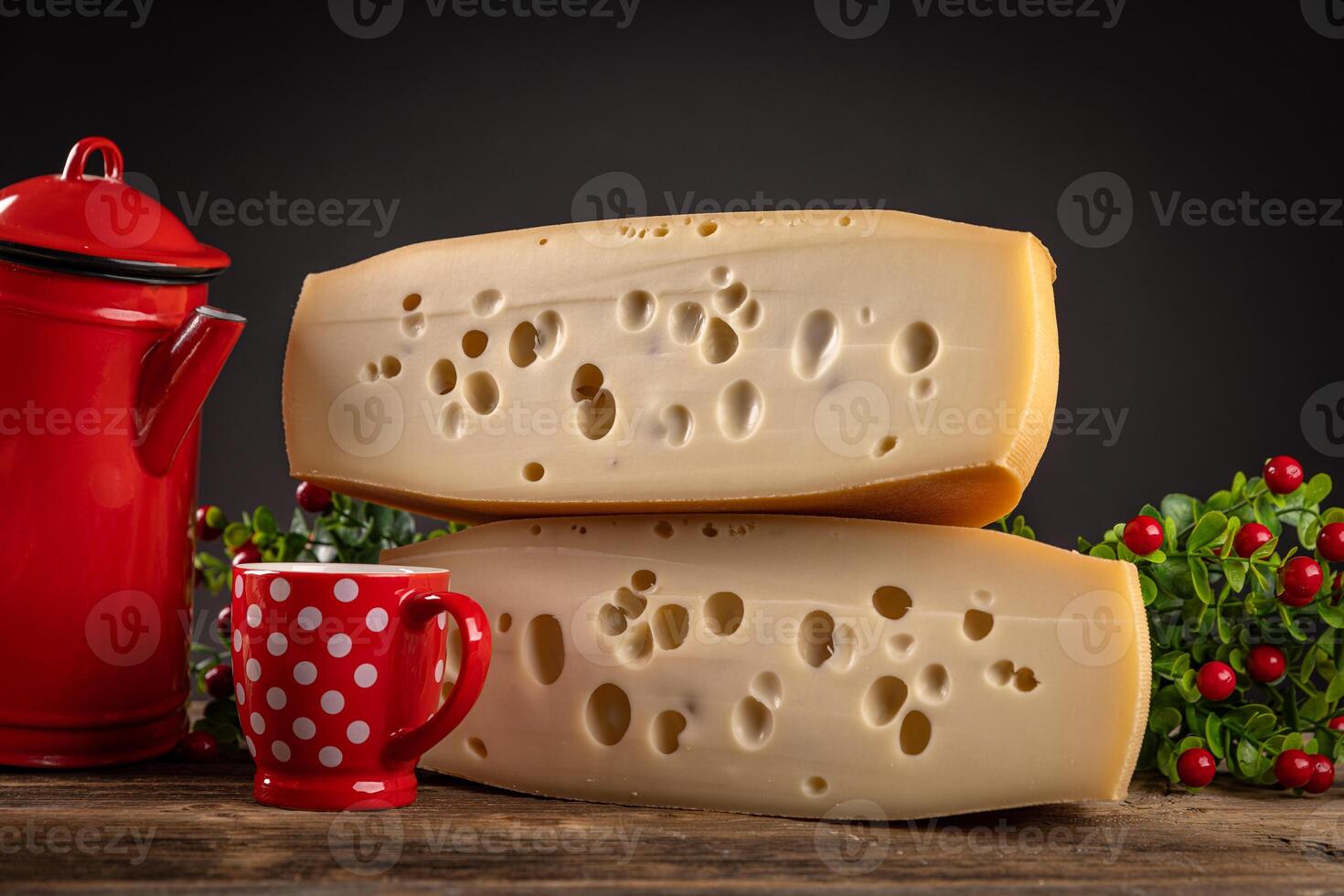 Two blocks of swiss cheese on wooden table photo