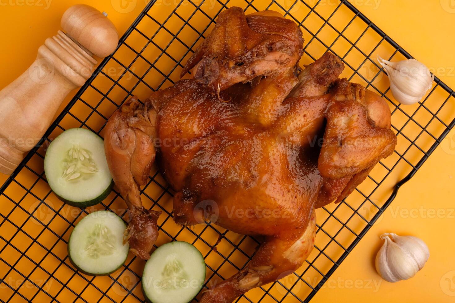 Ayam Panggang. Whole roasted chicken with soy sauce and spices. on the cooling rack. Indonesian food. photo