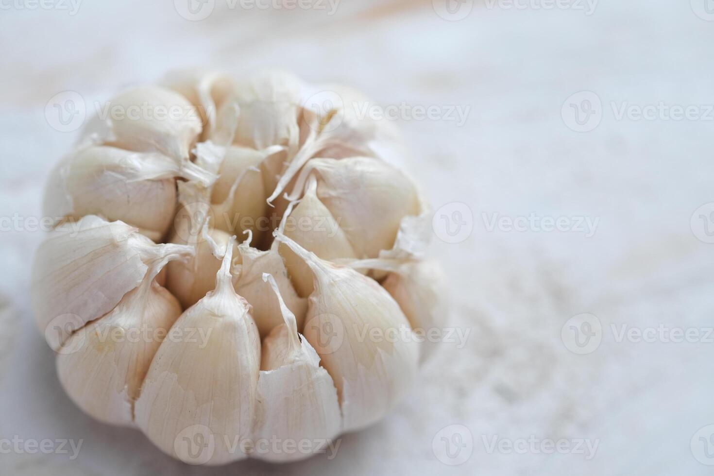 Allium sativum. whole piece of garlic on a white wooden table. photo