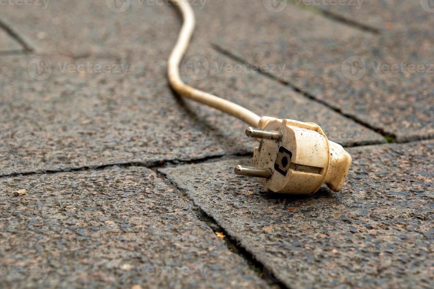 white electrical cord laying on the ground photo