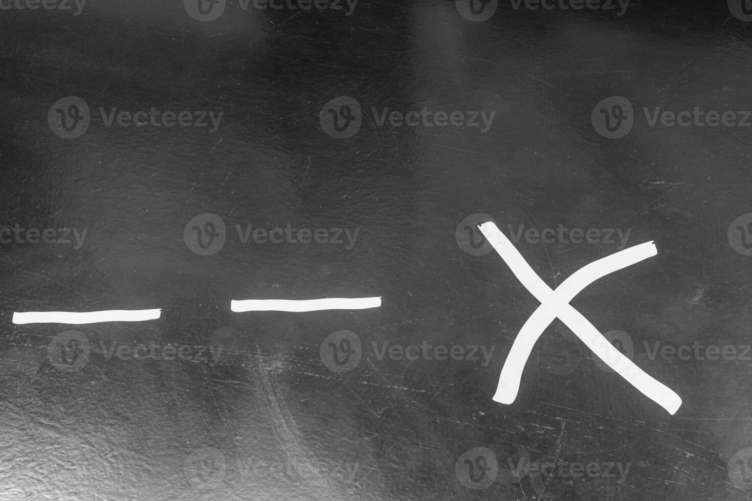 chalkboard with a white line and an X drawn on it photo