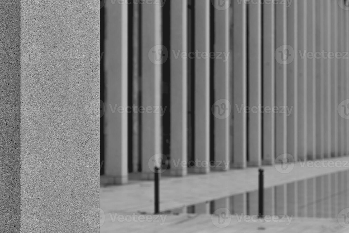 gray pillar with a black pole leaning on it photo