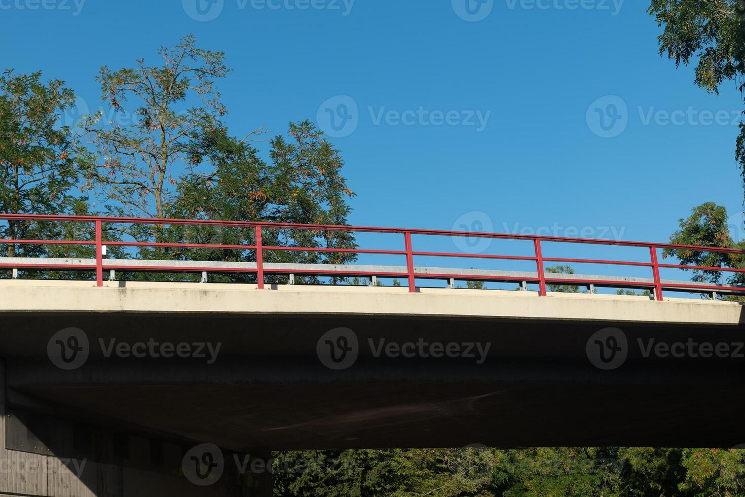 red metal railing sits atop a bridge photo
