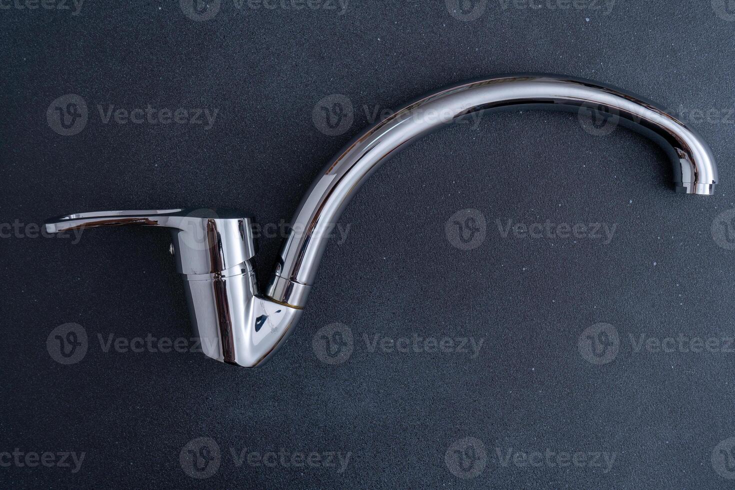 Chrome-plated mixer tap for water in the bathroom and kitchen. Plumbing. photo
