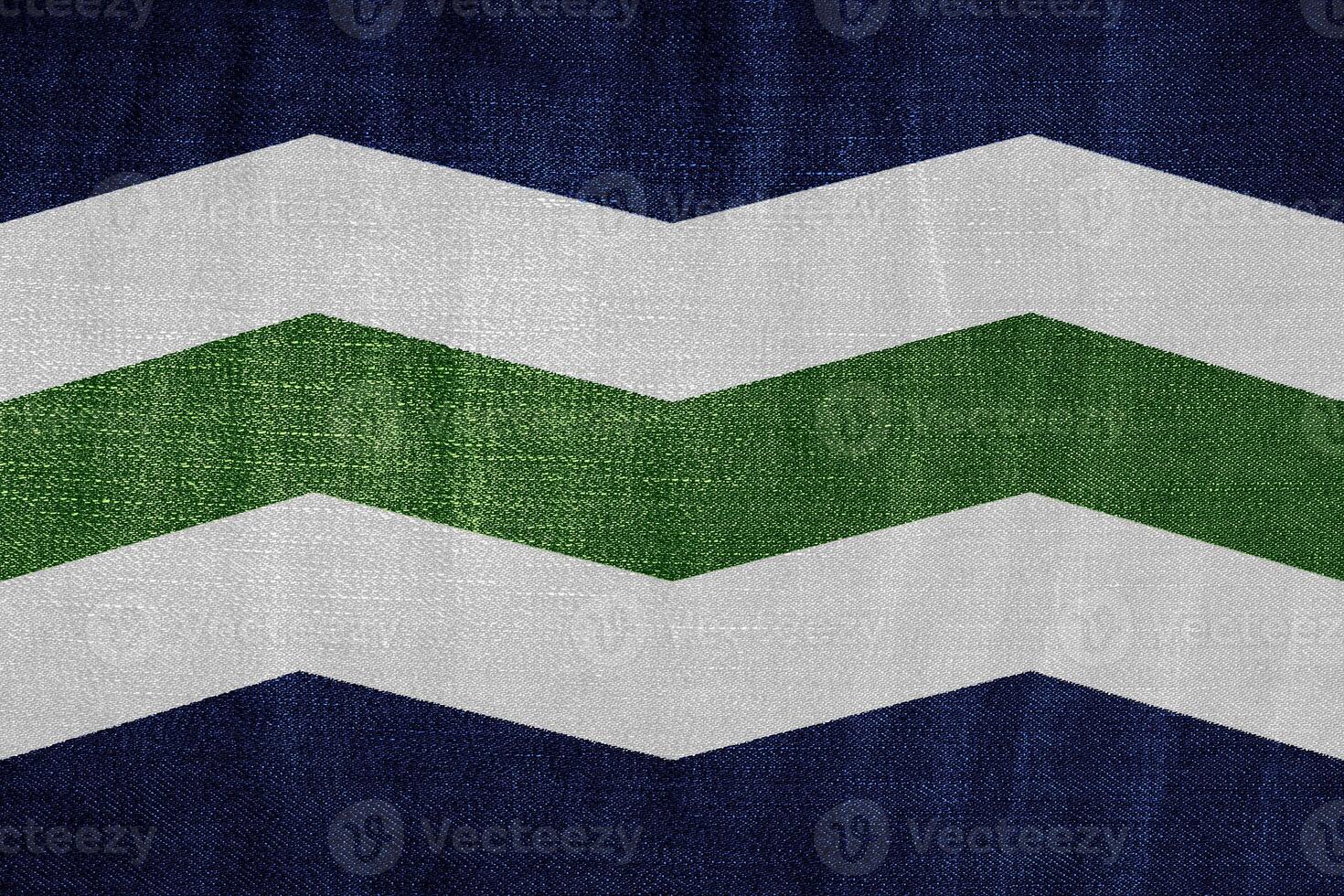 Flag of the city of Burlington, Vermont, USA, on a background of fabric texture. Conceptual collage photo
