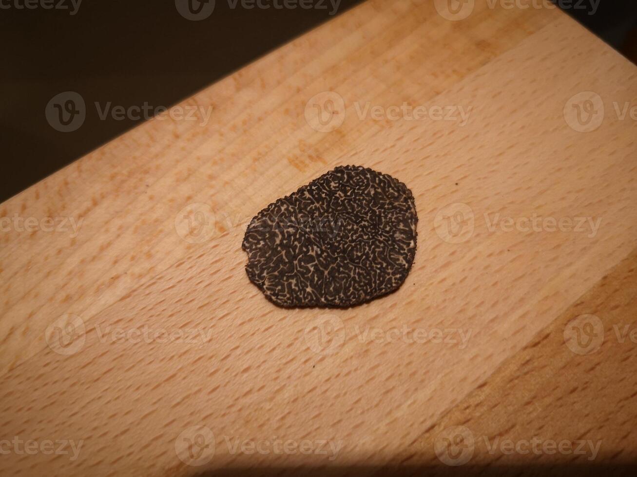 Sliced black truffle on wooden board photo