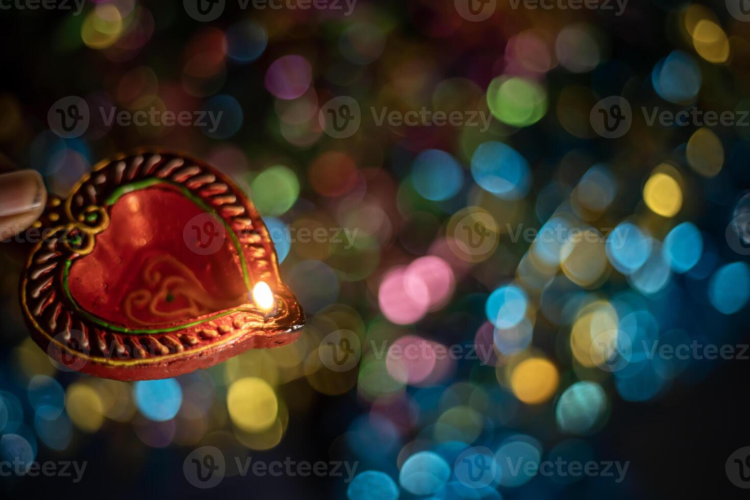 Love concept. Heart shape candle on colorful bokeh background for Valentine's day. photo