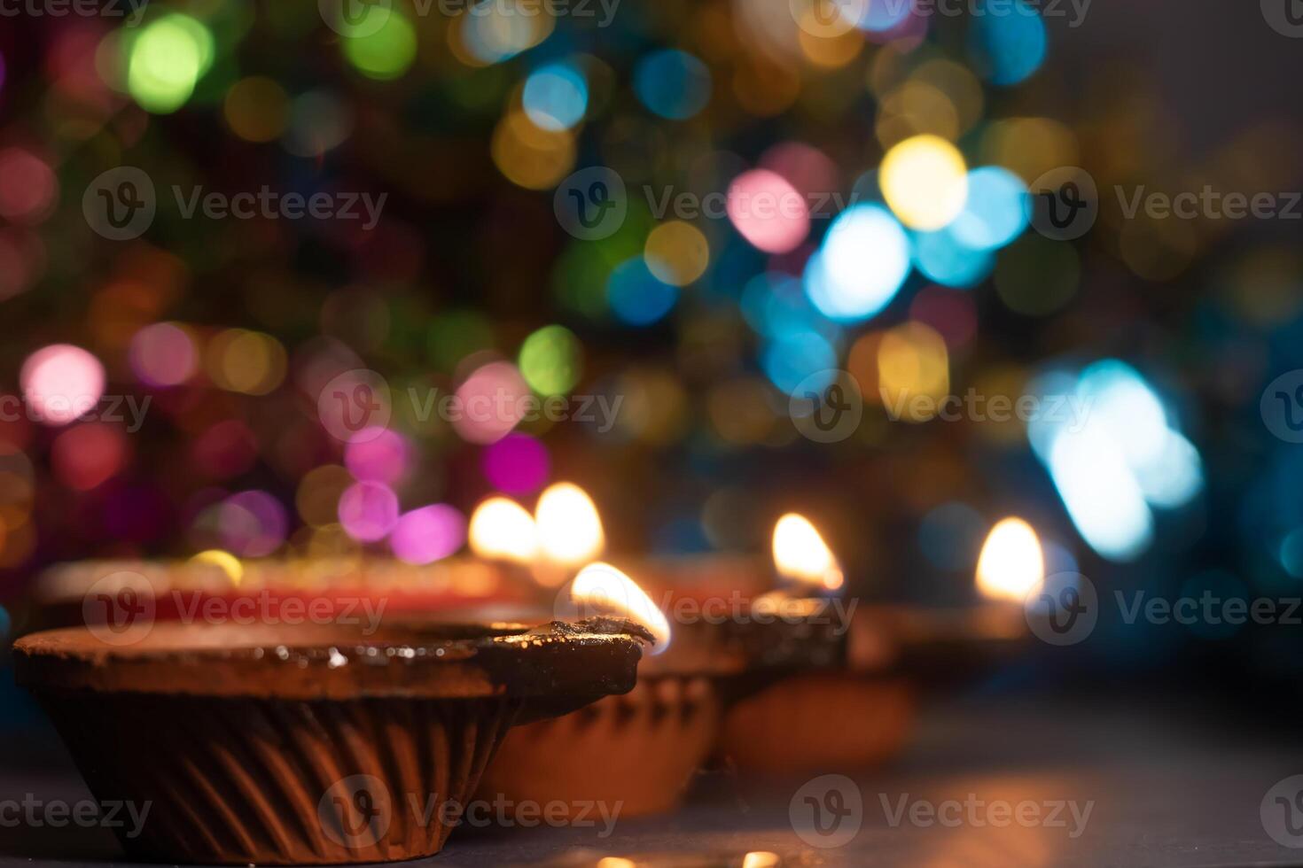 Glowing clay lanterns during Indian festival Diwali celebrations with bokeh effect background with copy space. photo