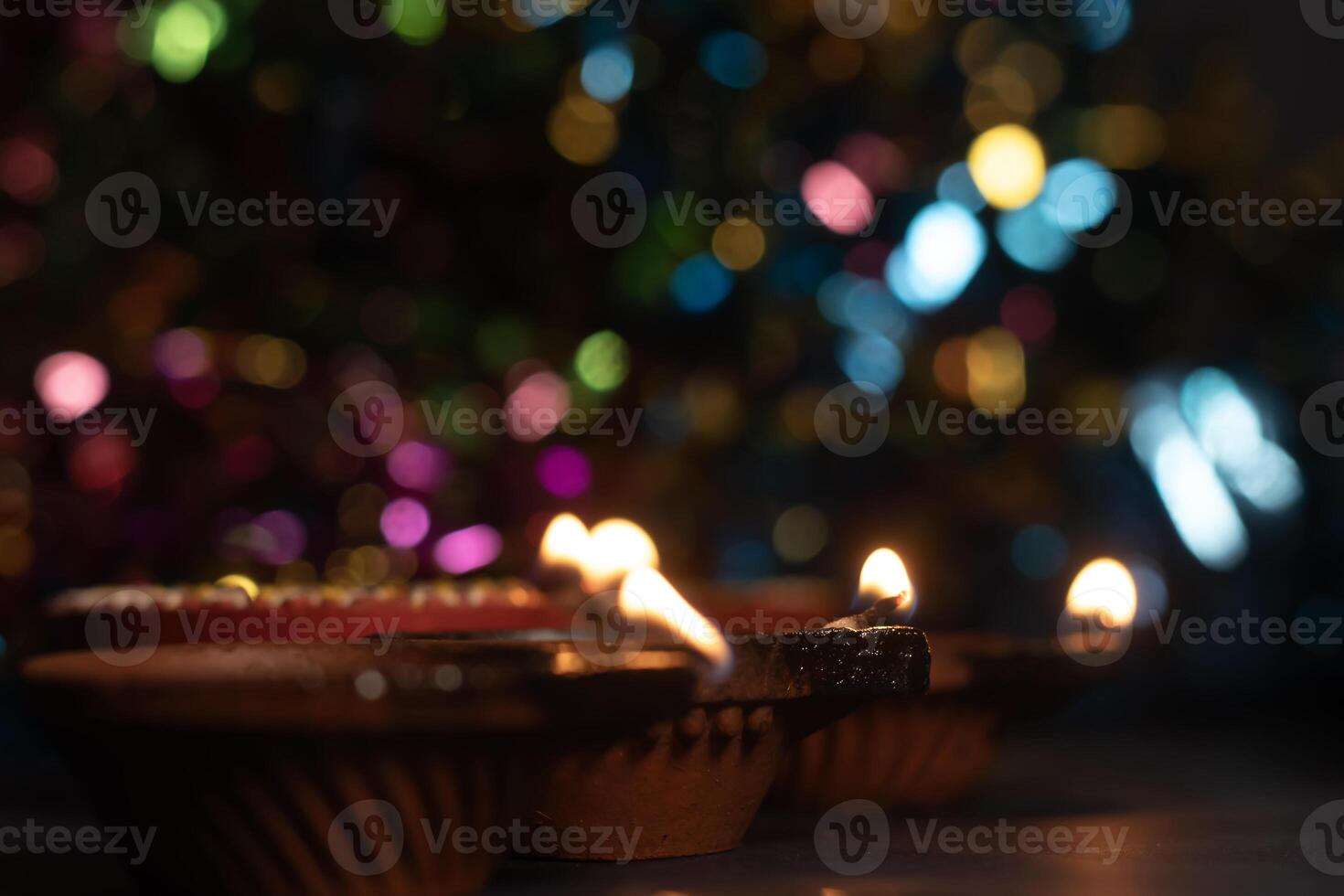 Glowing clay lanterns during Indian festival Diwali celebrations with bokeh effect background with copy space. photo