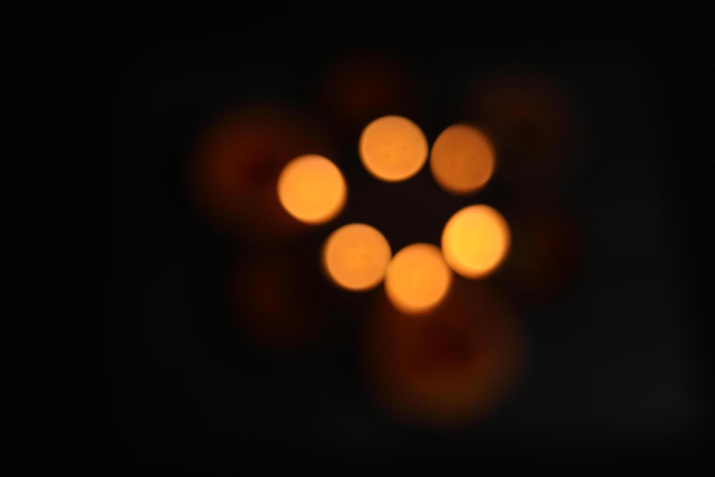 Defocused Of glowing clay lamps on black background. Bokeh effect. photo