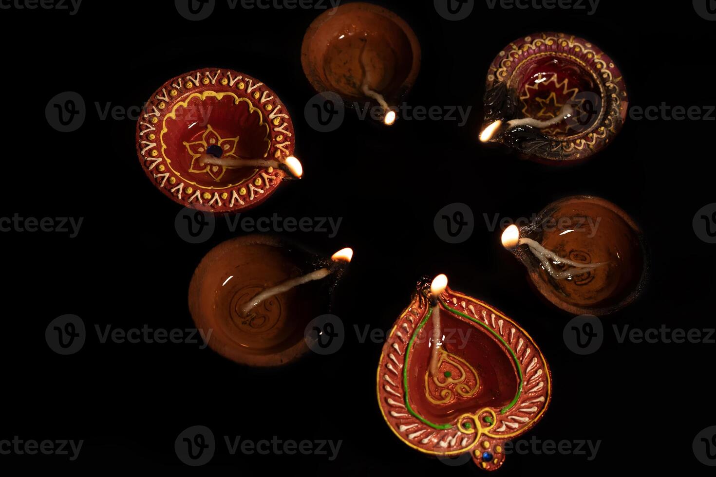Hindu festival of lights. Diwali oil lamps lit during on black background. photo