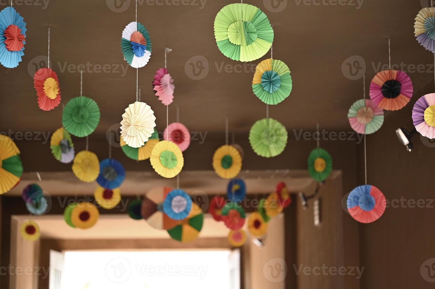 paper flowers hanging from the ceiling in a room photo