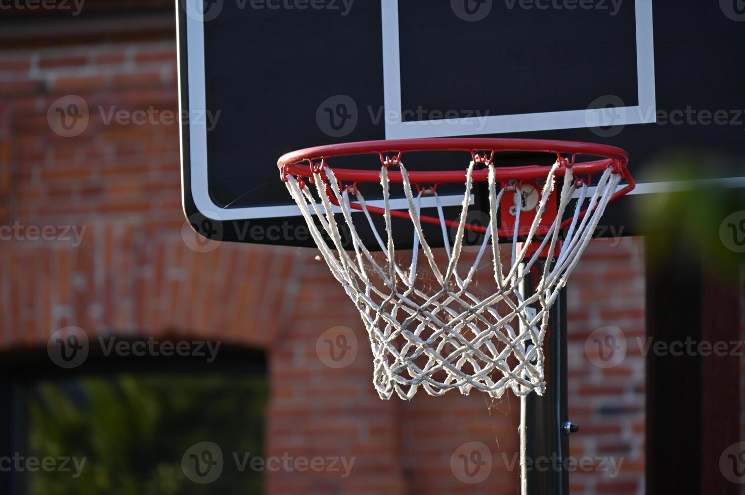 a basketball hoop is shown in front of a brick building photo