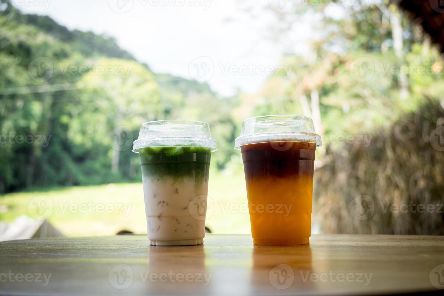 Black coffee separate layer with orange juice and green tea separate layer with fresh milk. photo