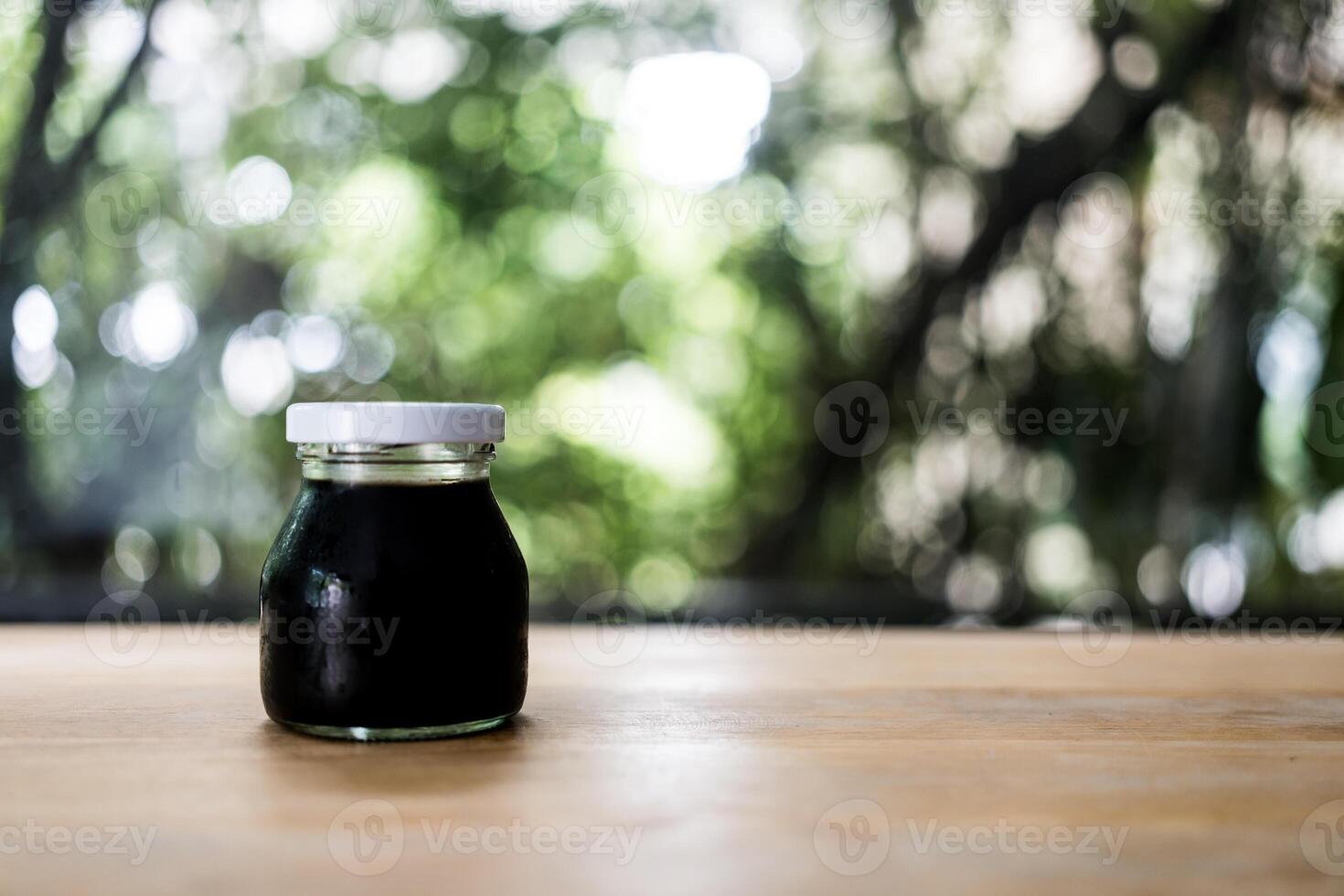Coffee in a mini glass bottle. Black coffee in glass jar photo