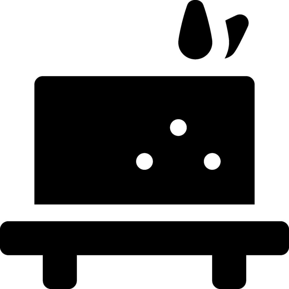 A black and white icon of a cake on a table vector