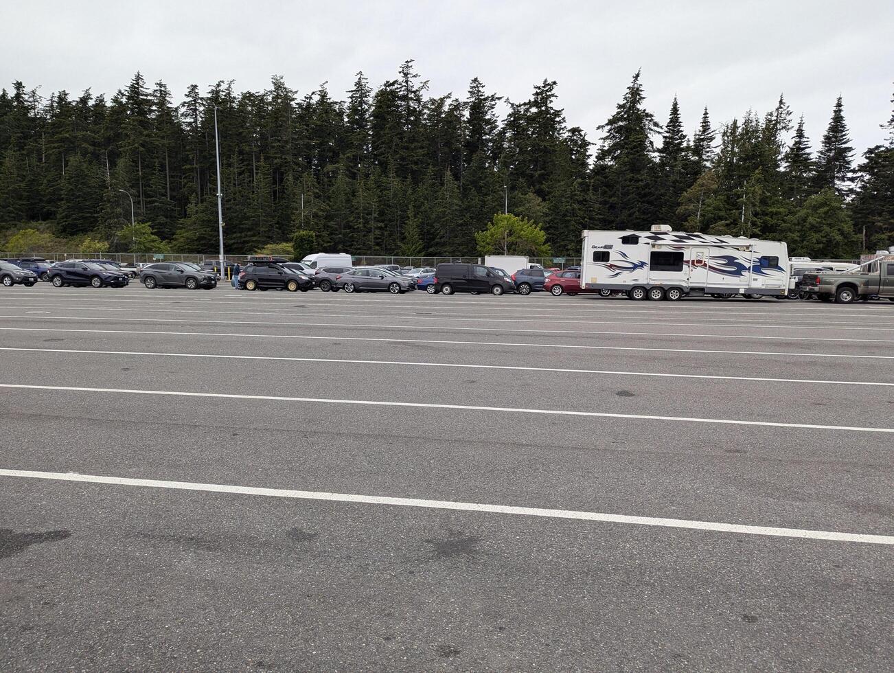 Anacortes, Washington, USA - 06.26.2024 A line of vehicles at the ferry terminal of the port of Anacortes on a cloudy day photo
