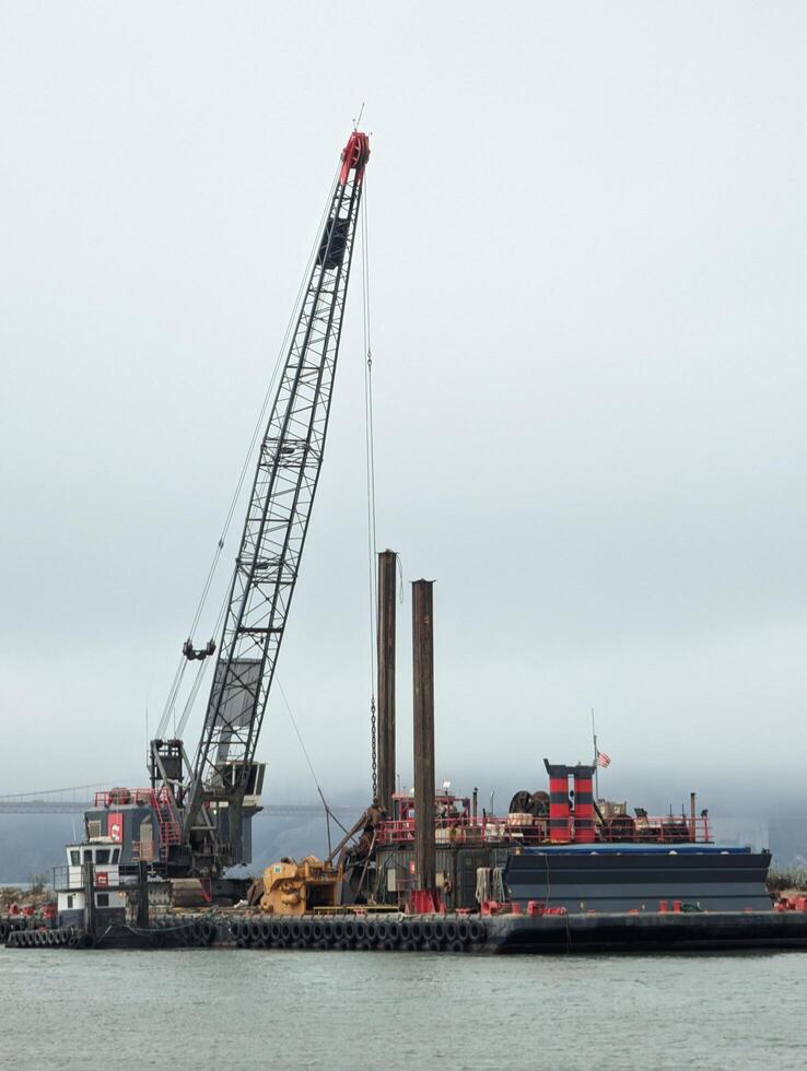 San Francisco - 09.20.2024 A crane on a barge performs repair work on the pier. Close-up photo