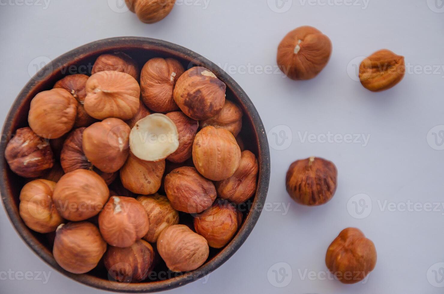 hazelnuts peeled in a plate on a light background photo
