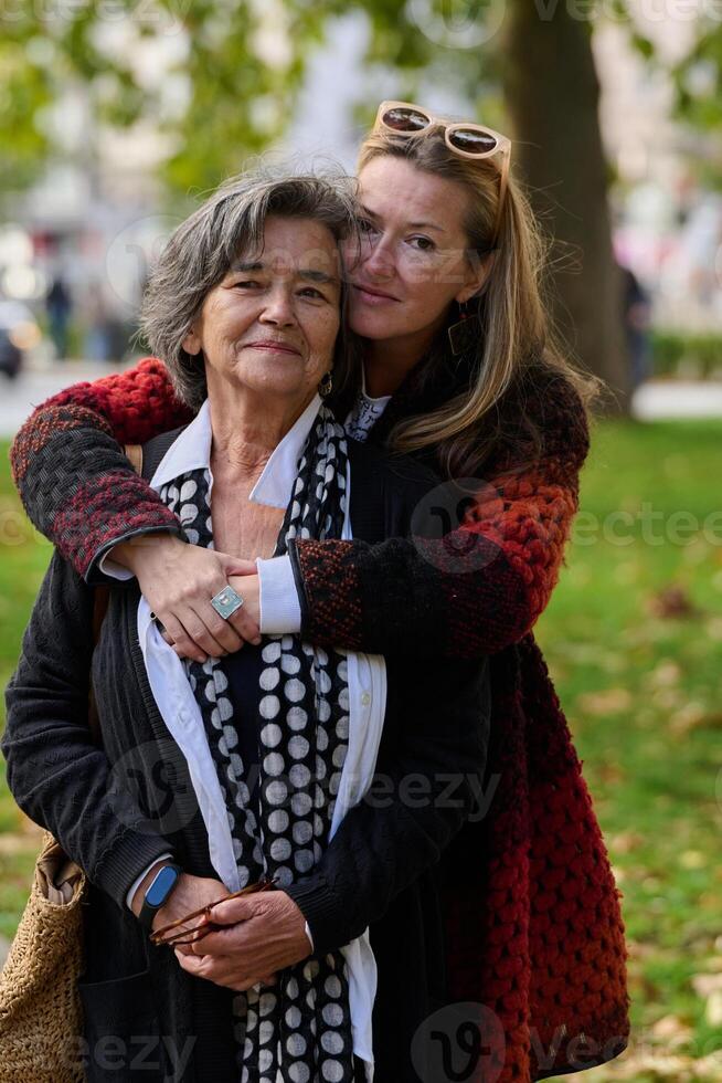 A Heartfelt Embrace. A Daughters Support for Her Mother on a Beautiful Autumn Day. photo
